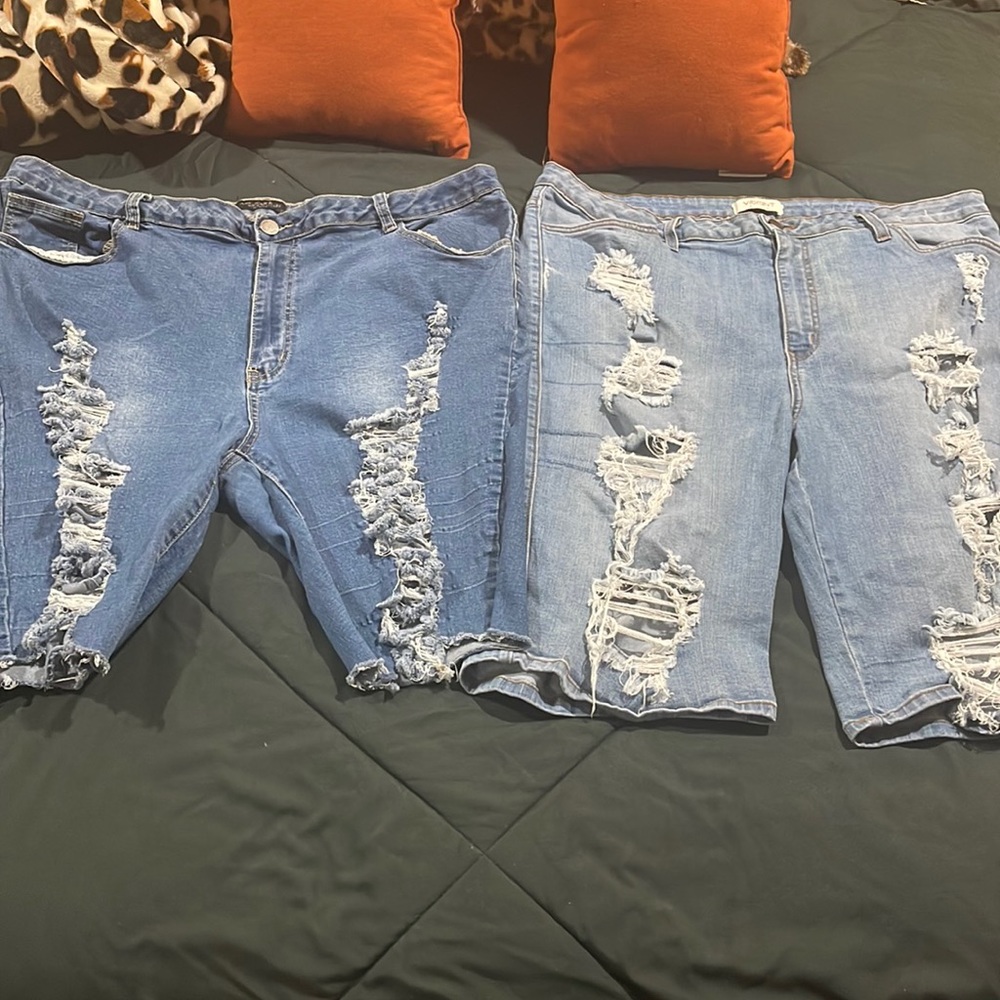 Two pair of distressed jean shorts.